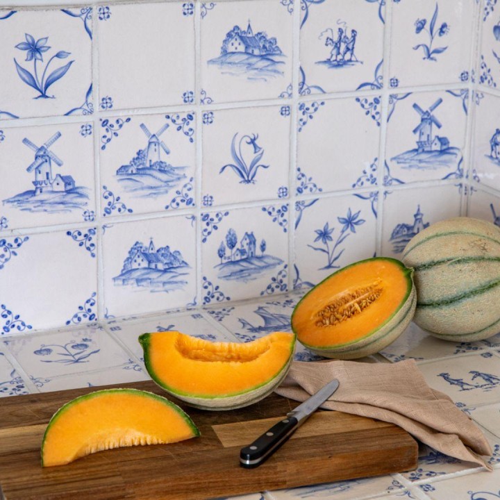 Classic Delft rustic Chalk White wall tiles in Rosalind Blue close up with Melons