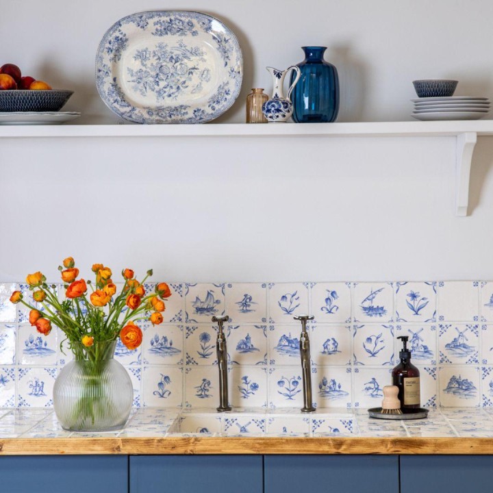 Classic Delft rustic Chalk White wall tiles in Rosalind Blue kitchen with vase of roses