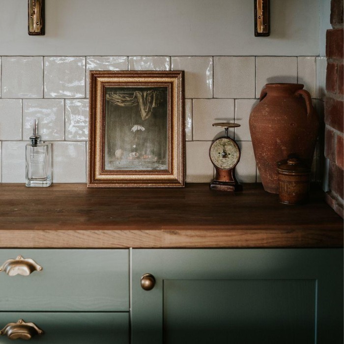 Aged Crackle wall tiles in the green kitchen of Willow Marsh Farm