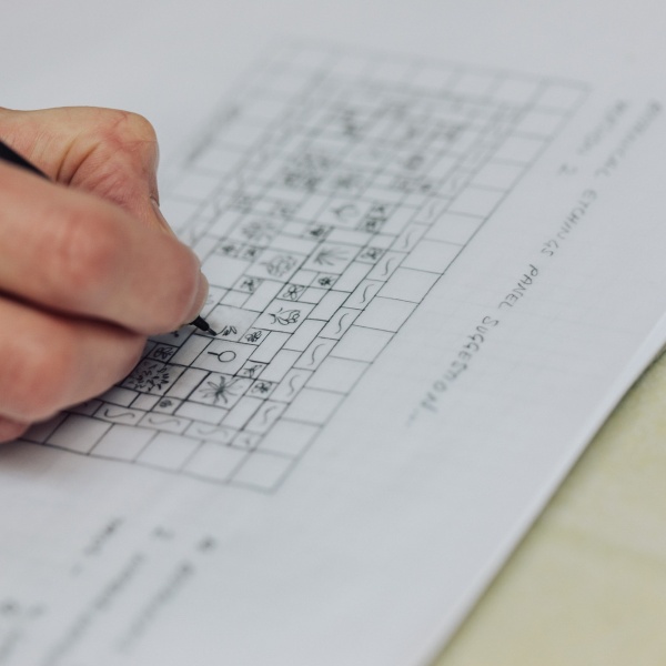 Close up of a hand drawing a tile layout design