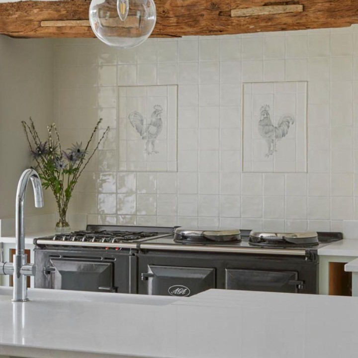 Handpainted cockerel tile panels in a kitchen designed by Lucy Marsh behind an AGA range cooker 1