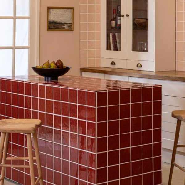 Chroma Tuscan Red square wall tiles on a kitchen island with Victorian Pink wall tiles on wall behind