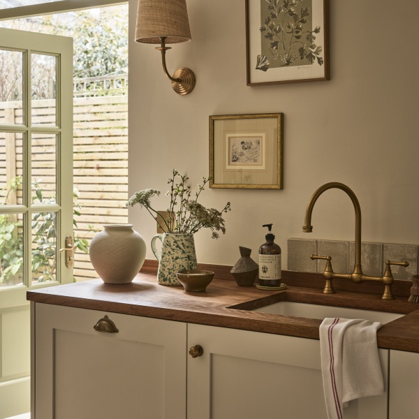 Pale green handmade tiles above an Autumnal kitchen sink