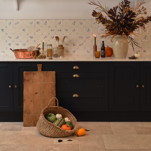 Beautiful autumnal kitchen with hand painted tiles and porcelain floor tiles