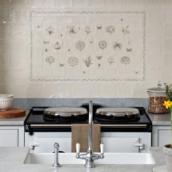 Hand painted botanical tile panel above a range cooker.
